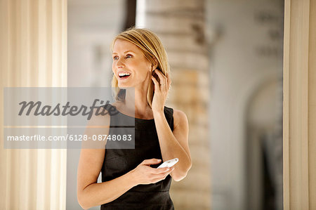 Businesswoman txt messaging on her cellphone.