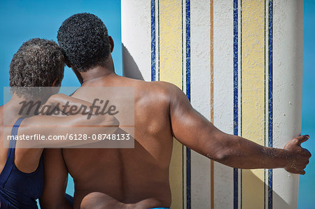 Mature couple standing together on a beach.