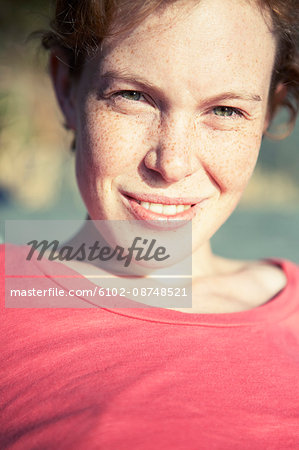 Portrait of freckled young woman smiling
