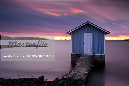 Wooden cottage on coastline