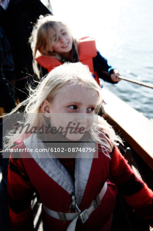 Portrait of children in a boat, Sweden.