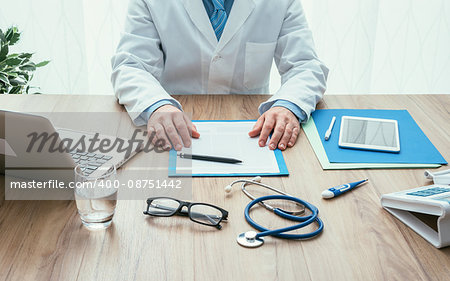 Professional doctor in his office working at desk, healthcare and hospitals concept