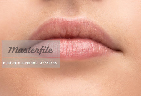 Beautiful young woman's full lips close-up, perfect skincare concept