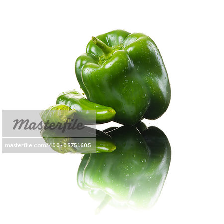 Fresh green bell pepper and chili peppers on white background.