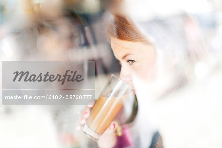 Woman drinking latte in cafe