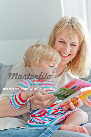 Mother with daughter reading book