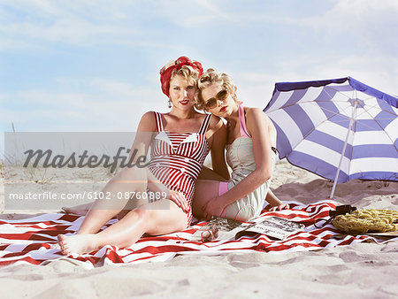 Two retro young women on beach