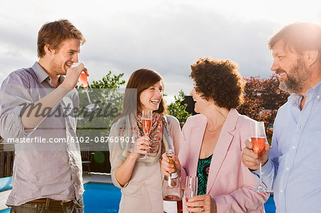 Happy people drinking champagne together