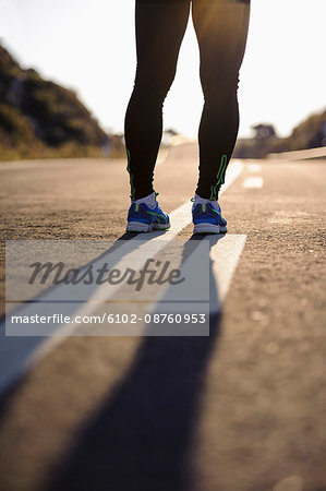 Runner standing on road