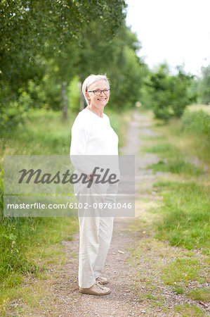 Senior woman standing on path