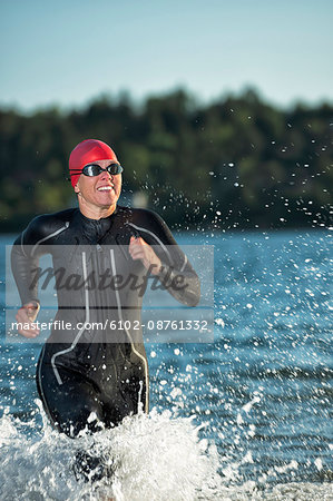 Woman in wetsuit in sea, Sweden