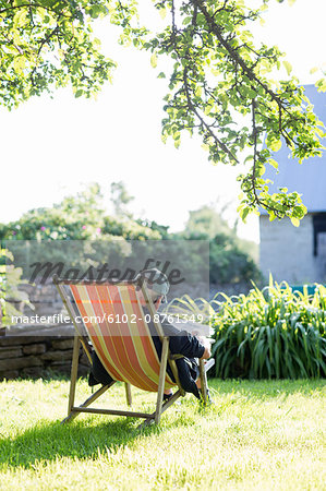 Man sitting on sun chair, Oland, Sweden