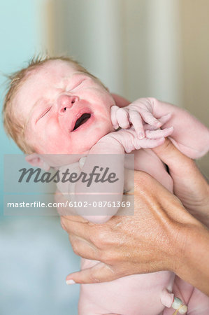 Hands holding newborn baby, Danderyd, Stockholm, Sweden