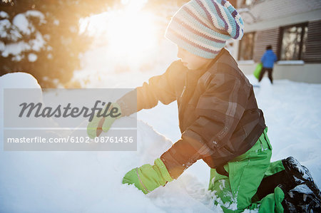 Boy playing at winter, Saltsjobaden, Nacka, Sweden