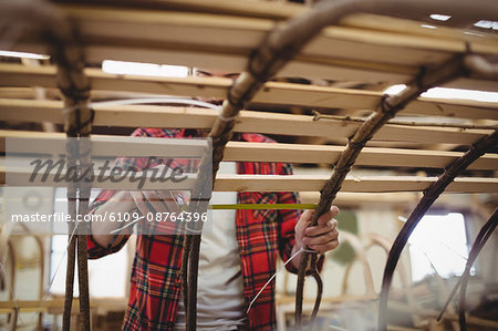 Man preparing a wooden boat frame at boatyard