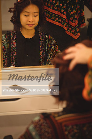 Stylish woman getting her hair done at a professional hair salon