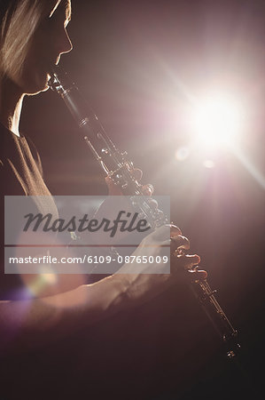 Woman playing a clarinet in music school