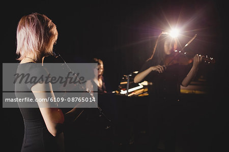 Women playing various instrument in music school