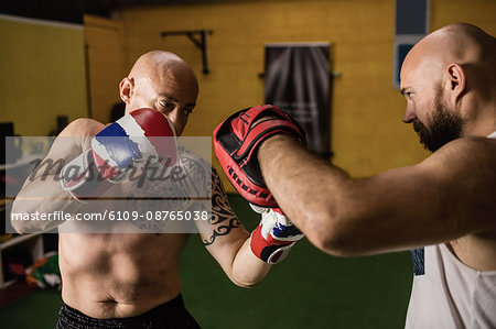 Thai boxers practicing boxing in the fitness studio