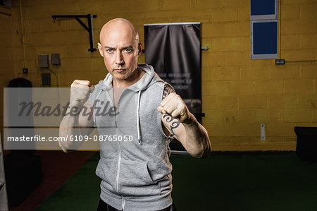 Portrait of thai boxer practicing boxing in the fitness studio