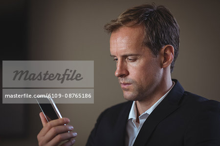 Businessman using his mobile phone at office