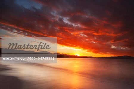 Dramatic red sunset at Cala Sabina Beach in Golfo Aranci in the Province of Sassari in Sardinia