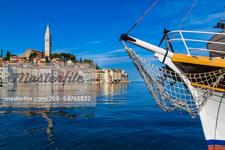 Waterfront and skyline of Rovinj with fishing boat in the north Adriatic Sea in Istria, Croatia