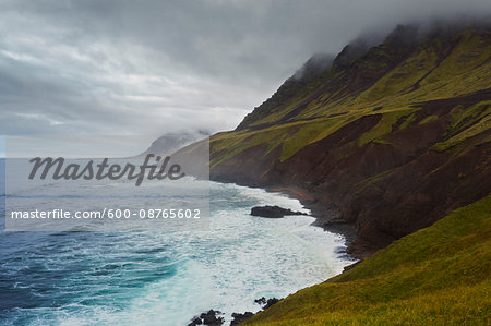 Fog over the cliffs of the Icelandic coast and the Atlantic Ocean in Northeast Iceland