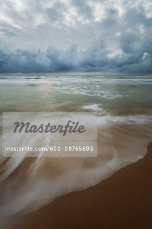 Cloudy sky over the Tyrrhenian Sea and blurred surf on the sands of the beach at San Felice Circeo in the Province of Latina in Lazio, Italy