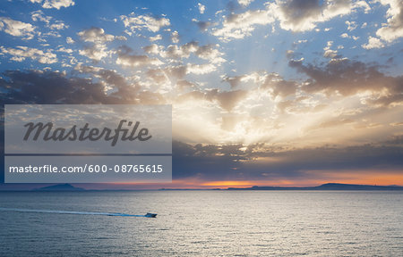 Boat cruising on the Gulf of Naples at sunset on the coast of Sorrento Peninsula in Campania, Italy