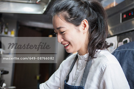 Chef in commercial kitchen smiling