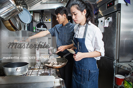 Chefs cooking in commercial kitchen