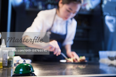 Chef in commercial kitchen preparing food