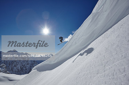 Male freestyle skier jumping mid air from mountainside, Zugspitze, Bayern, Germany