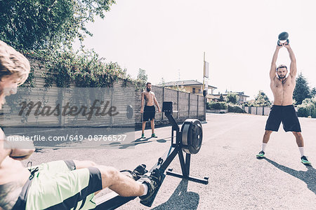 Three young male cross trainers training outside gym