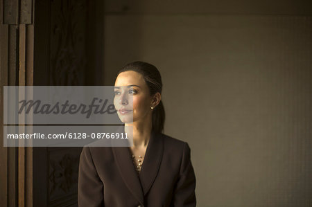 Solemn,  elegant young woman poses for a portrait.