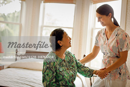 An elderly woman is helped by her doctor.