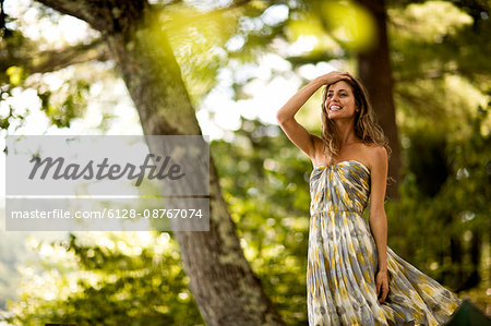 Portrait of woman in green dress in the woods.