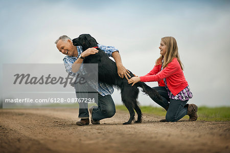 Dog playfully jumping up on its owner.