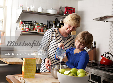 Mother and daughter in kitchen preparing food