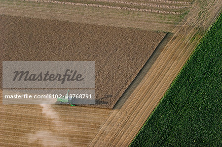 Agricultural machine in arable land, aerial view, Skane, Sweden.