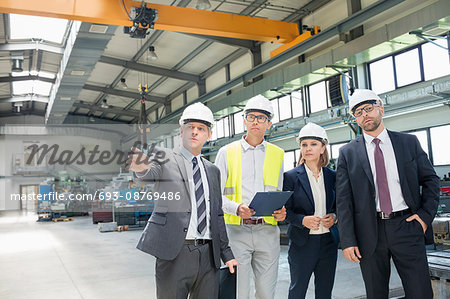 Businessman discussing with colleagues in metal industry