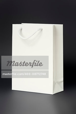 An image of a white shopping bag on a black background