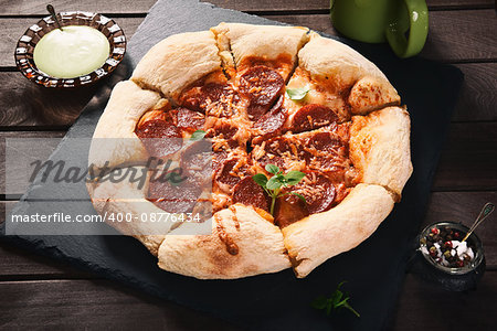 Hot Homemade Pepperoni Pizza on a rustic wooden table