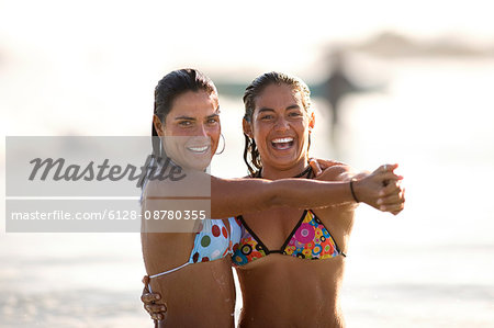 Two girls dancing on beach