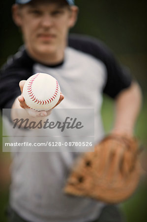 Baseball being held by a pitcher.