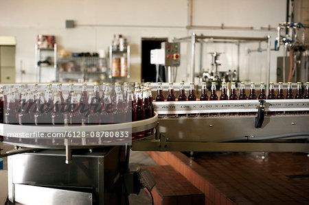 Group of bottles o a production line in a factory.