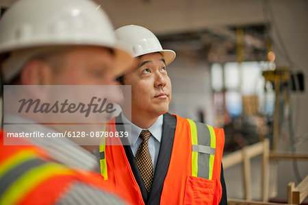 Middle aged businessman observing a construction site.