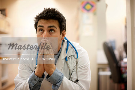 Anxious doctor sitting in his office.