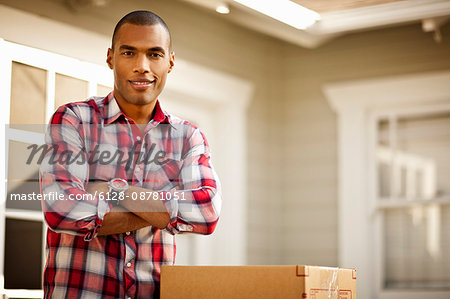 Portrait of mid-adult man outside his new home.